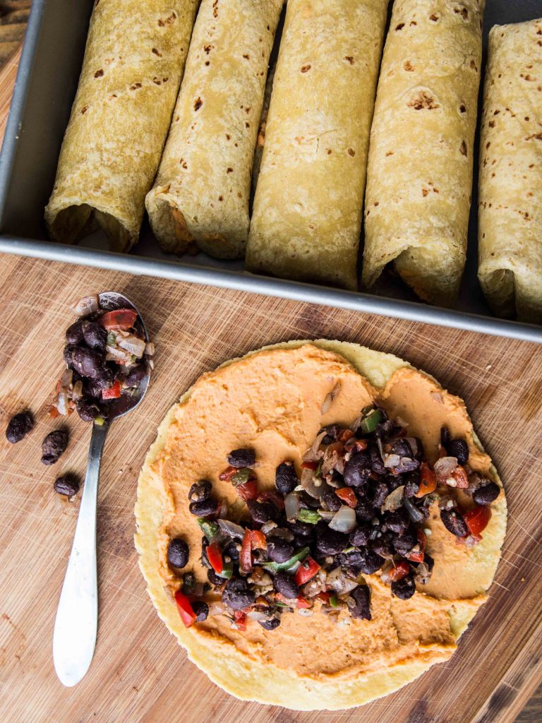 High Protein Sweet Potato, Pinto and Black Bean Enchiladas with White Cheddar Sauce // veggieandthebeastfeast.com