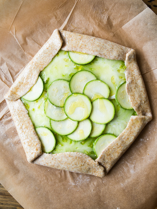 Zucchini and Heirloom Tomato Galette with Garlic Yogurt Sauce - summer veggies on top of creamy yogurt sauce, wrapped in a buttery whole wheat crust!