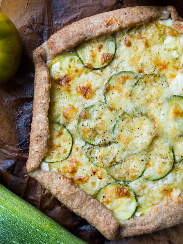 Zucchini and Heirloom Tomato Galette with Garlic Yogurt Sauce - summer veggies on top of creamy yogurt sauce, wrapped in a buttery whole wheat crust!