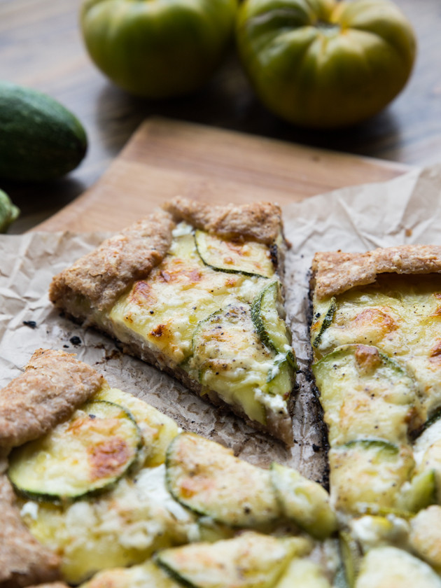 Zucchini and Heirloom Tomato Galette with Garlic Yogurt Sauce - summer veggies on top of creamy yogurt sauce, wrapped in a buttery whole wheat crust!