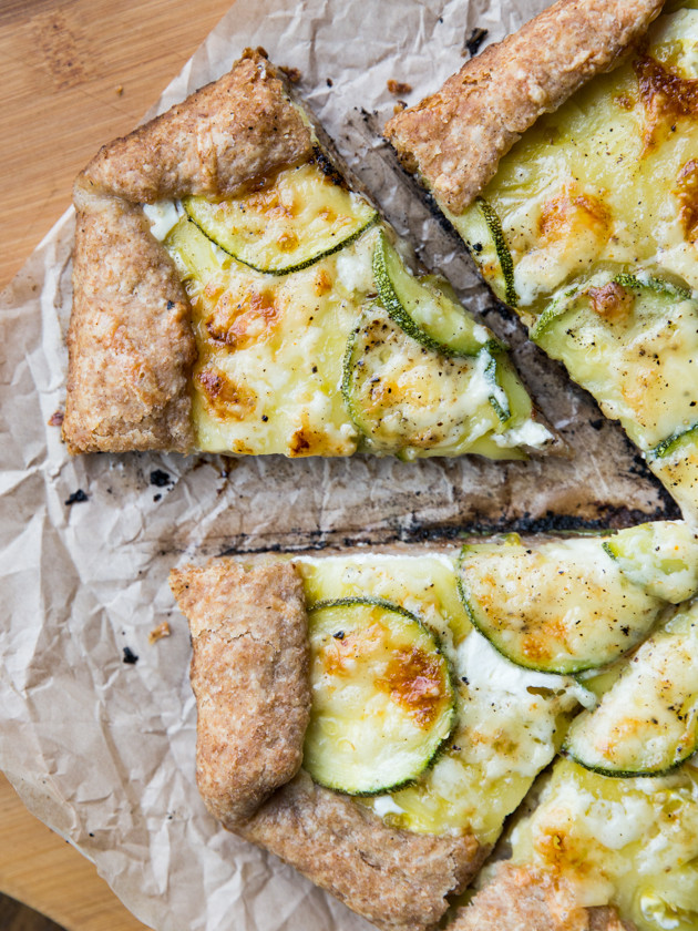 Zucchini and Heirloom Tomato Galette with Garlic Yogurt Sauce - summer veggies on top of creamy yogurt sauce, wrapped in a buttery whole wheat crust!