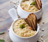Creamy Roasted Garlic White Bean Soup - Thick and creamy soup made with leeks, roasted garlic, and navy beans - easy, flavorful, and dairy free!